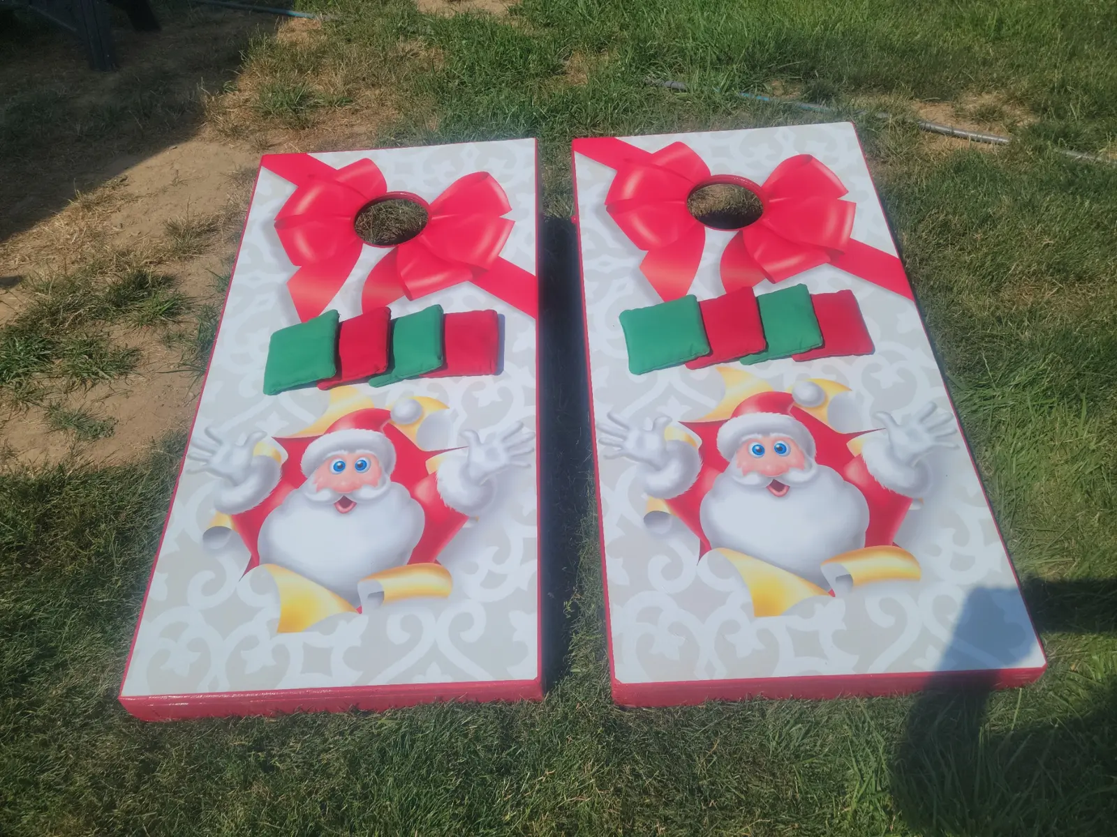 Santa-themed red and green cornhole boards