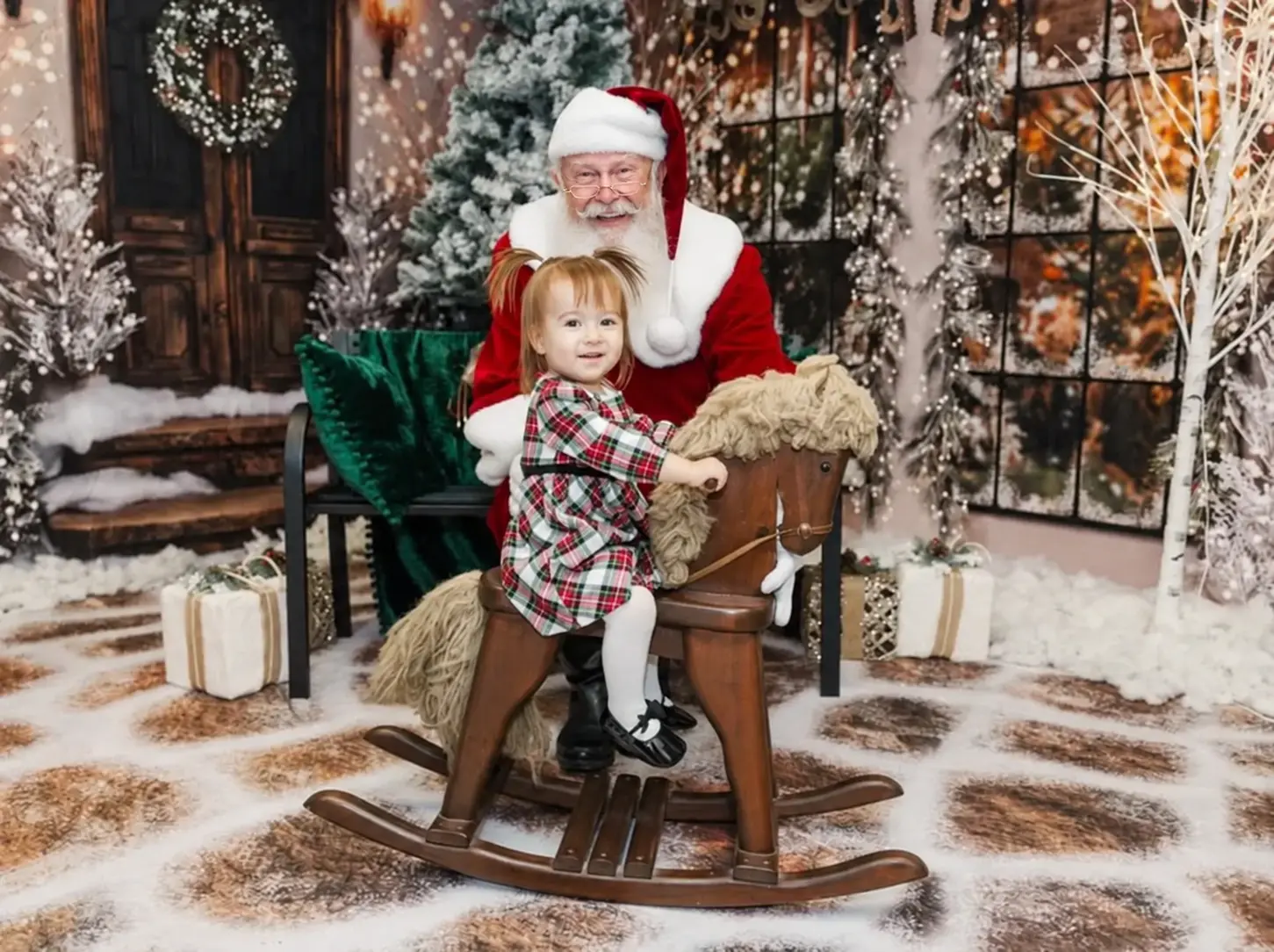 Santa Skip posing with a child on a rocking horse