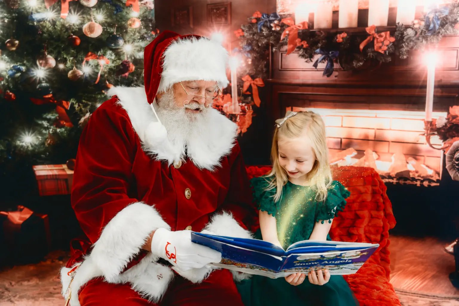 Santa Skip reading with a child beside the Christmas tree
