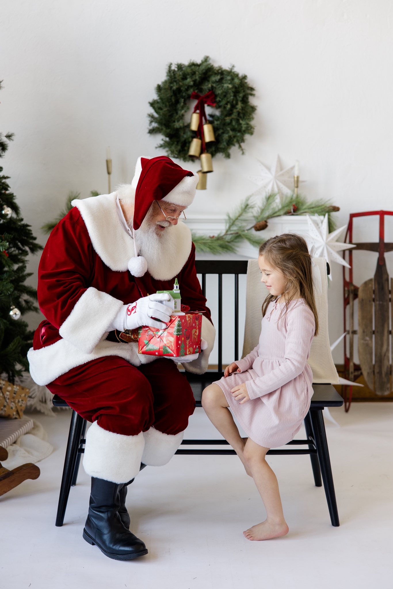 Santa Skip sharing a gift and conversation with a young girl